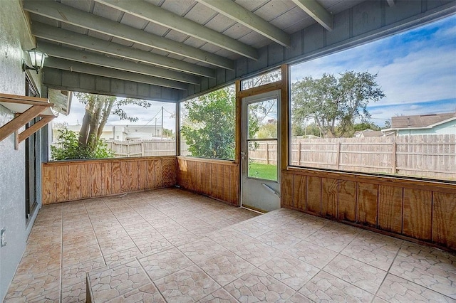 unfurnished sunroom featuring wood ceiling and beamed ceiling