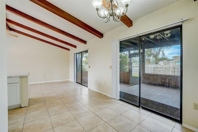 interior space featuring an inviting chandelier, light tile patterned floors, lofted ceiling with beams, and a textured ceiling