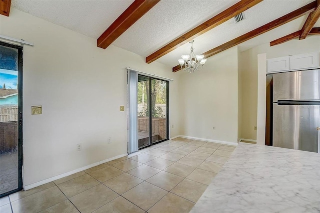 interior space with vaulted ceiling with beams, a chandelier, and a textured ceiling