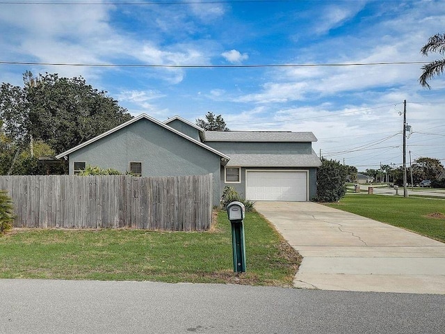 single story home featuring a garage and a front lawn