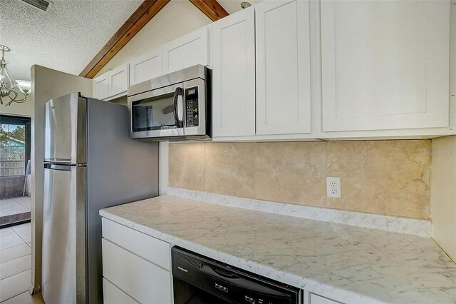 kitchen with white cabinetry, vaulted ceiling with beams, backsplash, stainless steel appliances, and a textured ceiling