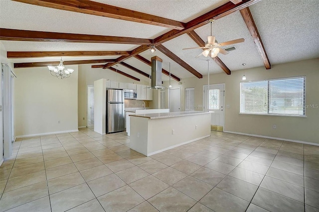 kitchen with white cabinetry, light tile patterned floors, stainless steel appliances, a textured ceiling, and wall chimney exhaust hood