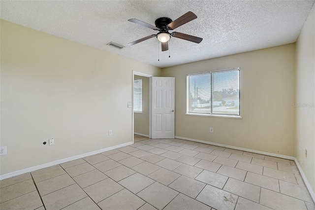 unfurnished room featuring light tile patterned floors, a textured ceiling, and ceiling fan