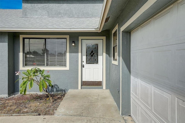entrance to property with stucco siding