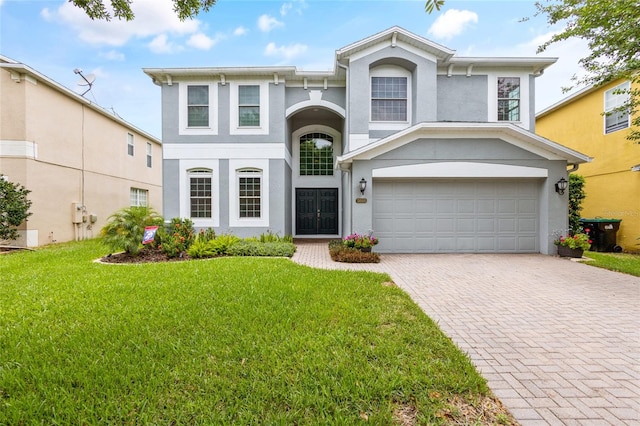 view of front facade with a garage and a front lawn