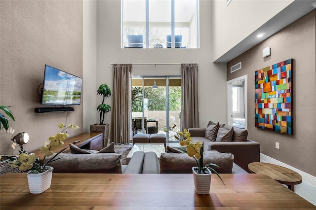 living room with a towering ceiling