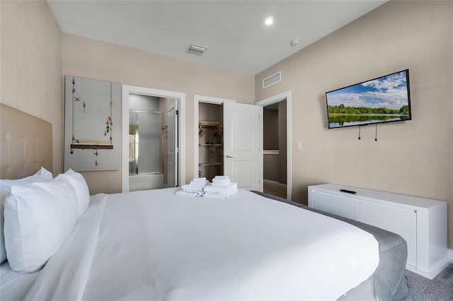 bedroom featuring ensuite bathroom and a walk in closet