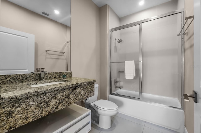 full bathroom featuring enclosed tub / shower combo, tile patterned floors, toilet, and vanity