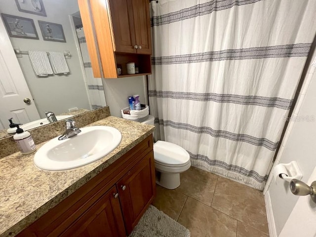 bathroom with tile patterned flooring, vanity, and toilet