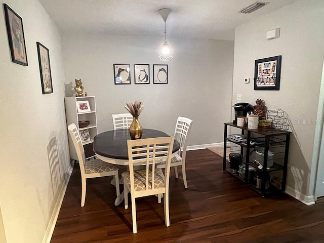 dining space featuring dark hardwood / wood-style floors