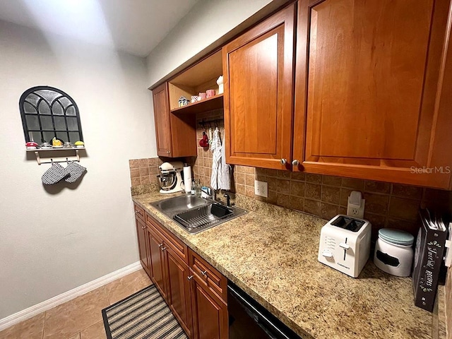 kitchen with sink, backsplash, light stone countertops, and light tile patterned floors