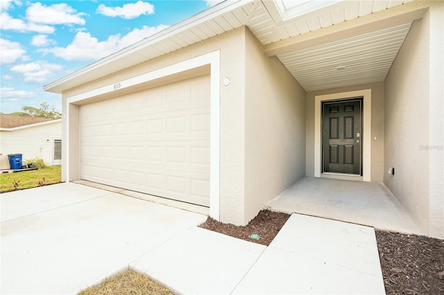 doorway to property with a garage