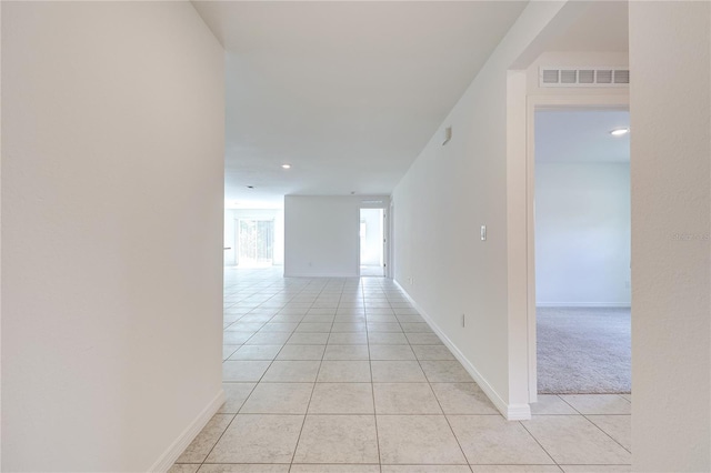 corridor with light tile patterned flooring