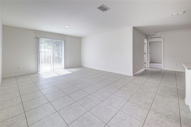 unfurnished room with light tile patterned floors