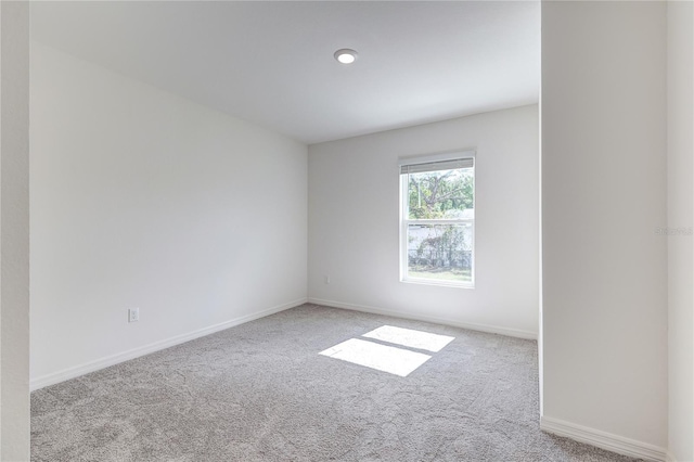 unfurnished room with light colored carpet