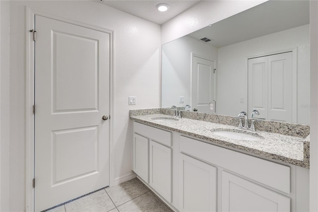 bathroom featuring tile patterned flooring and vanity