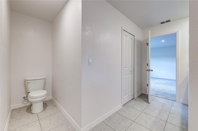 bathroom with toilet and tile patterned flooring