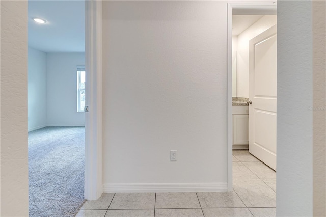 corridor featuring light tile patterned floors