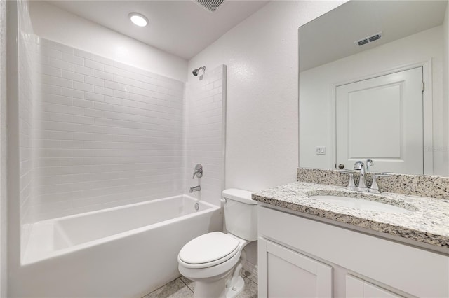 full bathroom with tiled shower / bath, vanity, and toilet