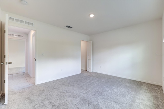 unfurnished room with light colored carpet