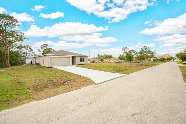 view of front of home with a garage and a front yard