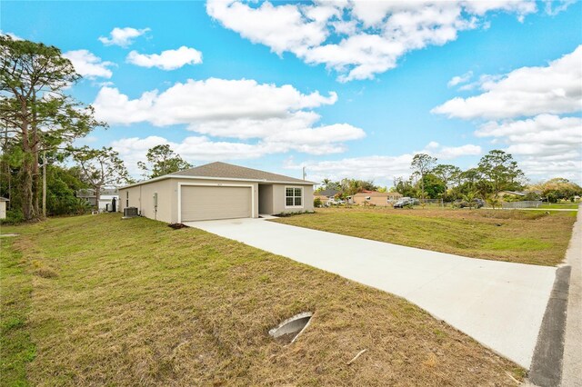 view of front of property with a garage, central AC unit, and a front yard