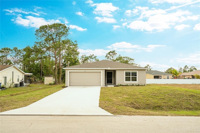 ranch-style home featuring cooling unit, a garage, and a front yard