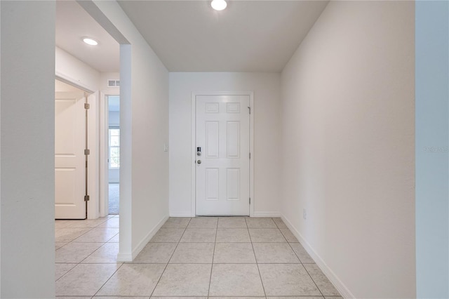 corridor featuring light tile patterned floors