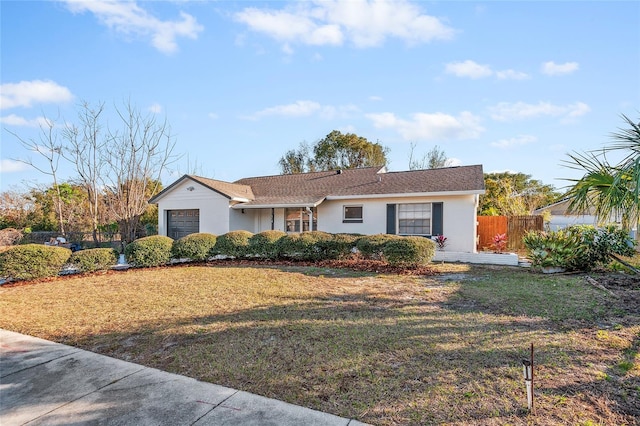 ranch-style home featuring a garage and a front yard