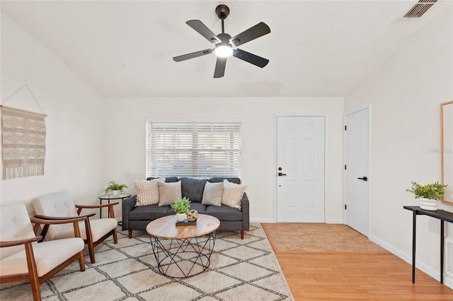 living room featuring ceiling fan and light hardwood / wood-style flooring