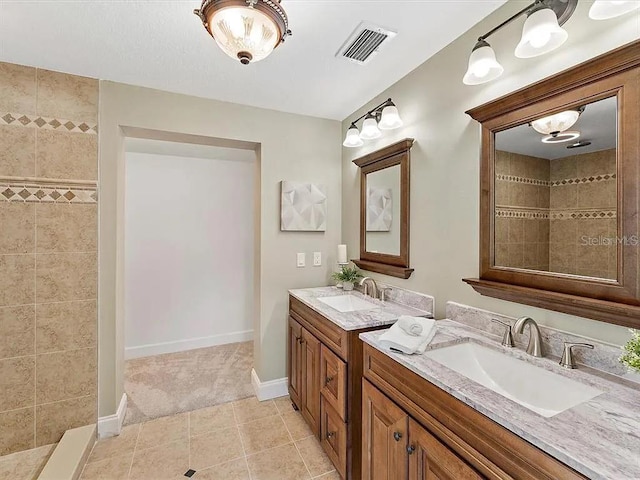 219 Nob Hill Cir, Longwood, FL 32779 - full bathroom featuring two vanities, visible vents, a sink, and a tile shower