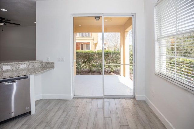 doorway with ceiling fan and light wood-type flooring