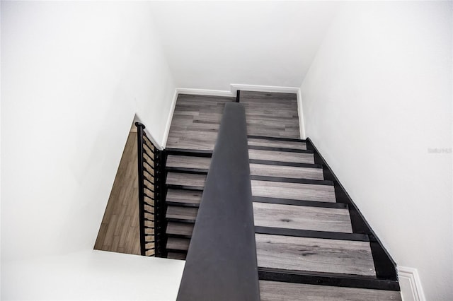 stairs with hardwood / wood-style flooring