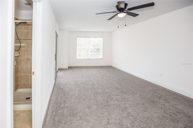 carpeted spare room with ceiling fan