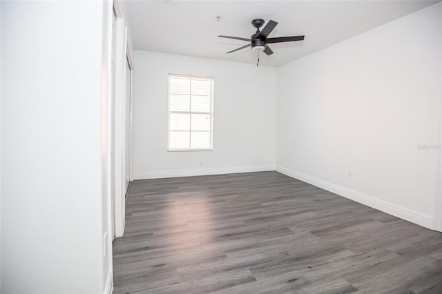 unfurnished room with dark hardwood / wood-style floors and ceiling fan