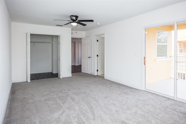 unfurnished bedroom with ceiling fan, a closet, and light carpet