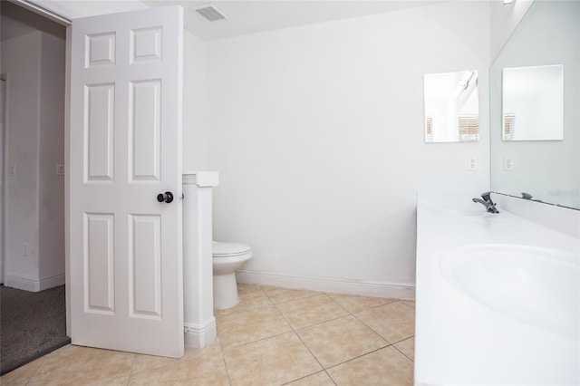 bathroom featuring vanity, toilet, and tile patterned flooring