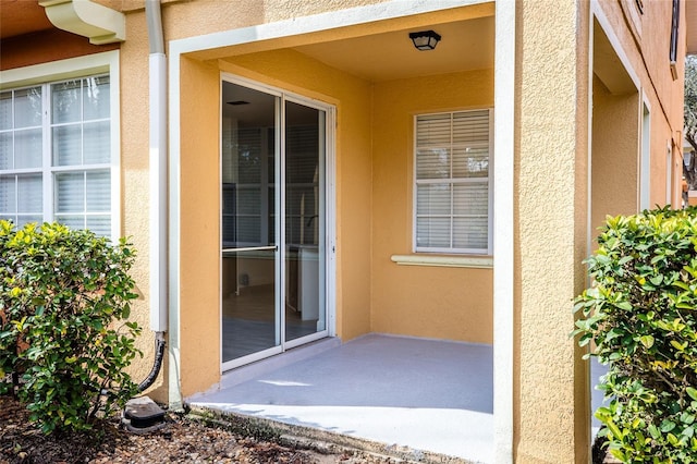 entrance to property with a patio