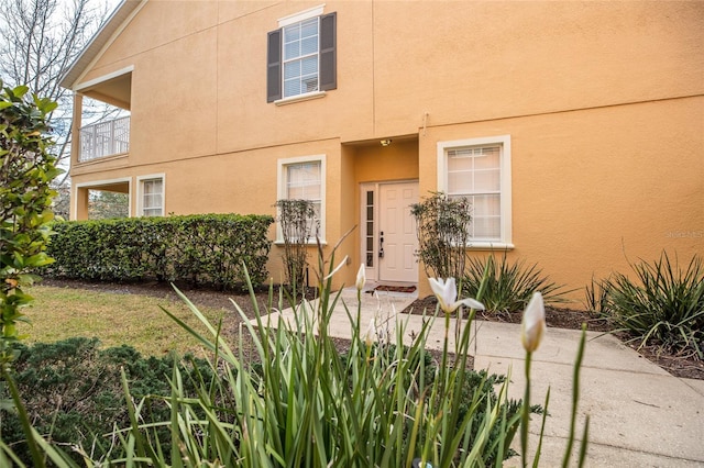 view of exterior entry with a patio area