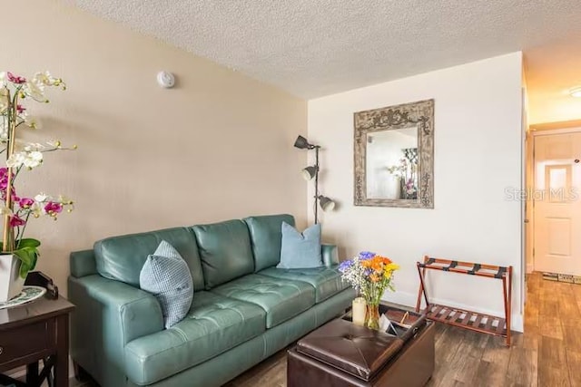 living room with dark hardwood / wood-style flooring and a textured ceiling