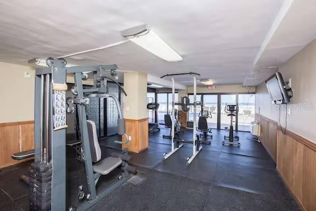 workout area featuring wood walls