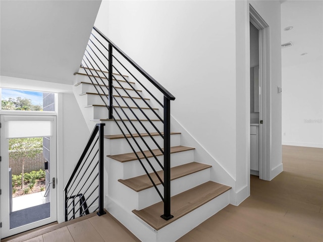 staircase featuring hardwood / wood-style flooring