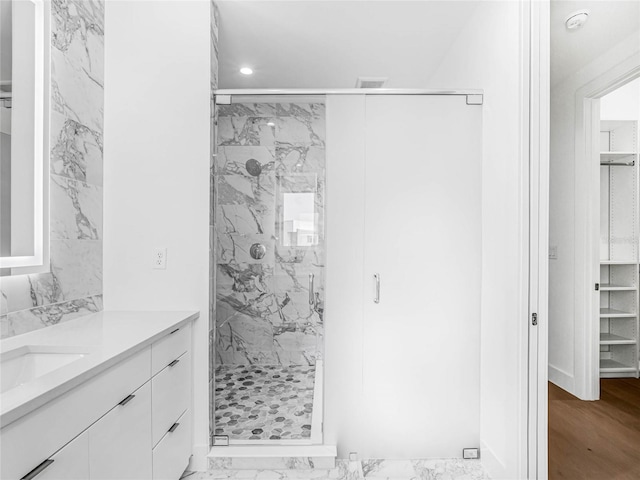 bathroom with vanity and a shower with shower door