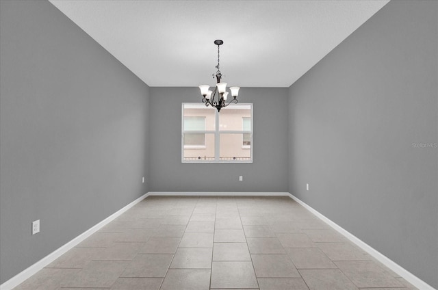 tiled empty room with a chandelier