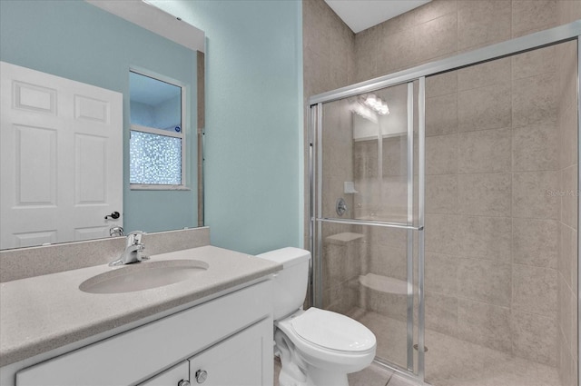 bathroom with vanity, an enclosed shower, and toilet