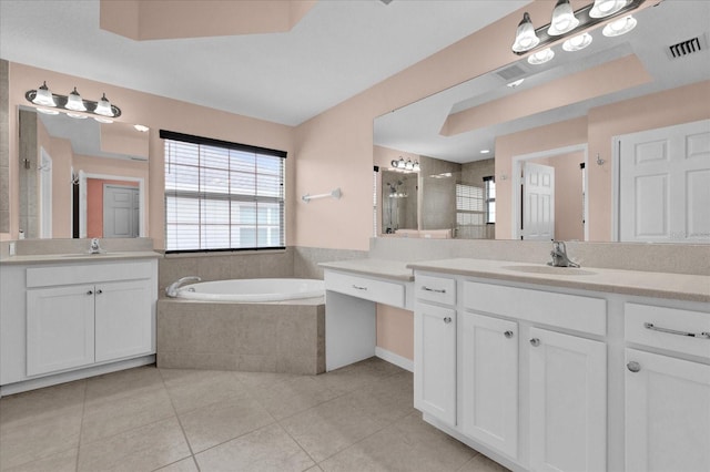 bathroom with tile patterned flooring, vanity, and shower with separate bathtub