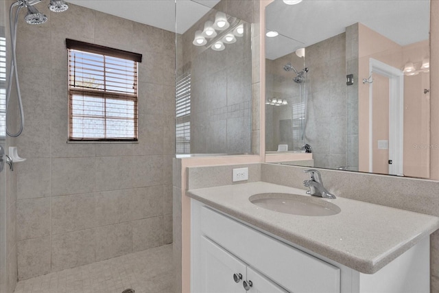 bathroom with vanity and a tile shower