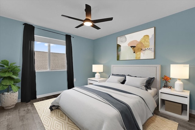 bedroom with hardwood / wood-style floors and ceiling fan