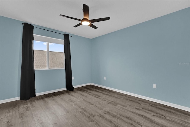 empty room featuring wood-type flooring and ceiling fan