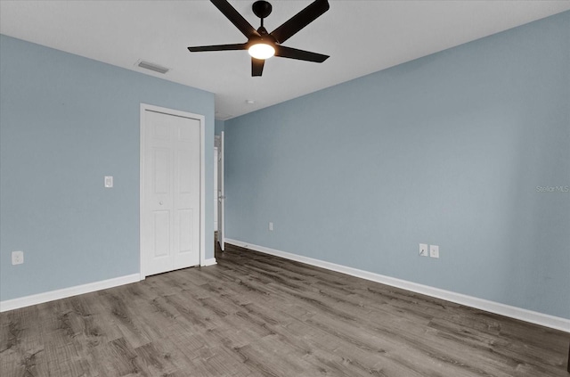 spare room with ceiling fan and light wood-type flooring